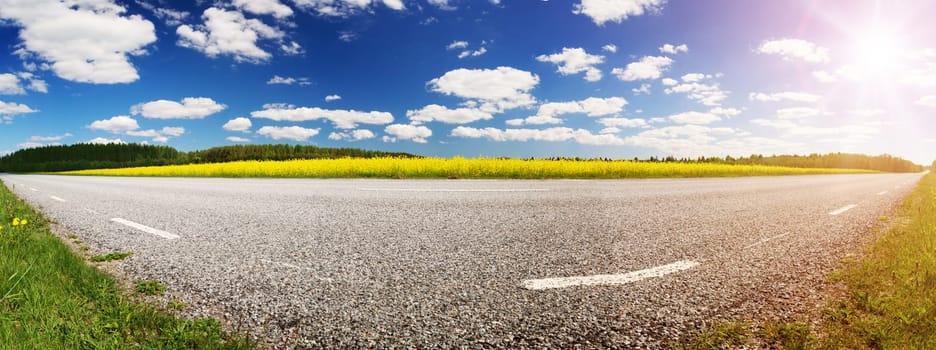 Asphalt road panorama in countryside on sunny summer day