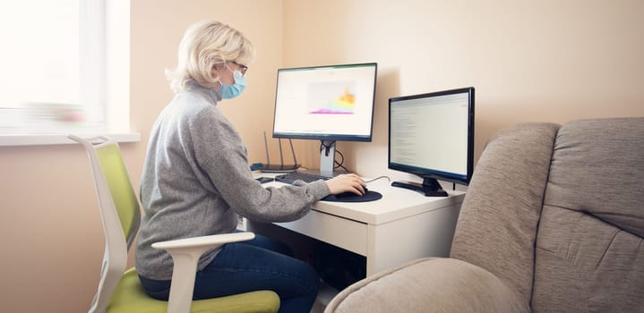 woman working at home in homeoffice. Young businesswoman sitting indoors and using pc