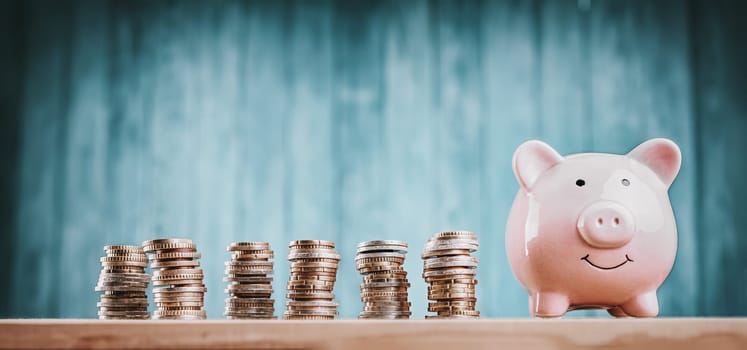 piggy bank with stacked coins. Pig with money savings on blue background