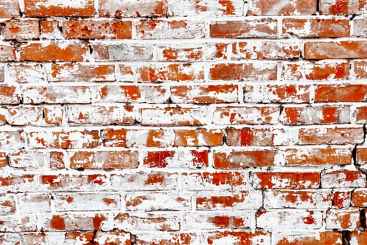 Rustic red brick background with white paint. Dirty wall pattern of an old building. Brickwall texture