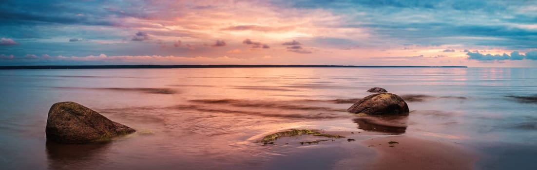 Rocky shores at the sea in sunset light. Lahemaa natural park coastal landscape with beautiful sky