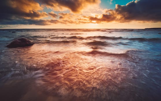 Seascape at sunset with rainy clous on the horizon