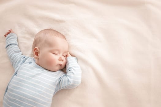 little boy sleeping on soft white blanket