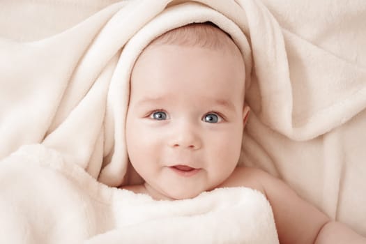 little boy sleeping on soft white blanket