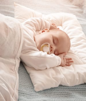 Four month old baby sleeping on blue blanket