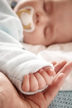 Four month old baby sleeping on blue blanket