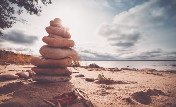 Stacked stones at evening light on the coast