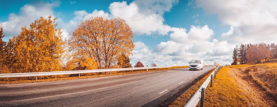 beautiful landscape on a highway in autumn. Road at falls on sunny day