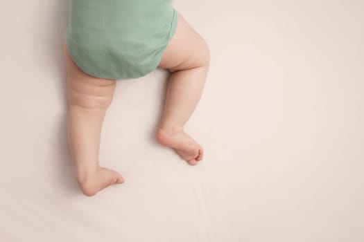 Baby feet on white background with blue blanket