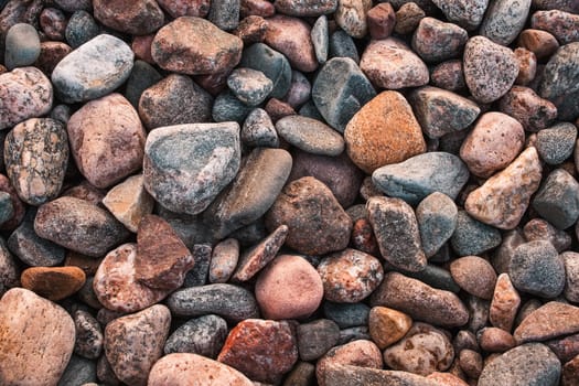 texture with multicolored stones on rocky beach in summer