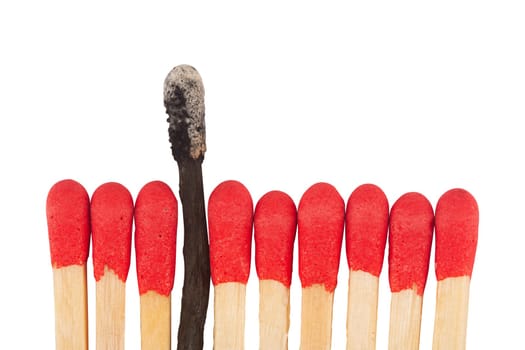 front view macro closeup of red wooden match sticks heads with a burnt one in the middle isolated on white background