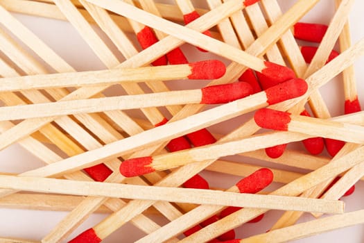 front view macro closeup of red wooden match sticks texture on white background