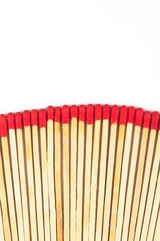 front view macro closeup of long red wooden match sticks isolated on white background