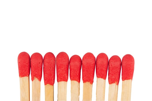 front view macro closeup of red wooden match sticks heads isolated on white background