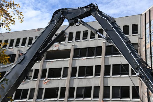 The façade of the office building is still standing. Demolition begins.