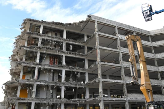 A high-rise building is professionally dismantled and recycled.