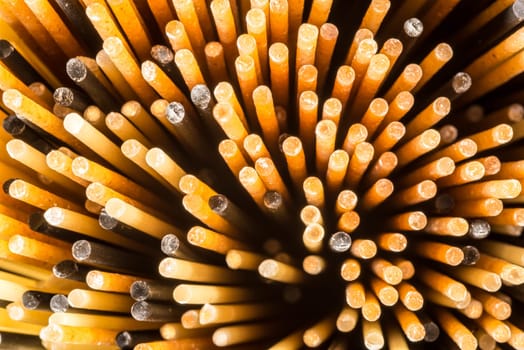 A close up view of the ends of three different types of spaghetti standing upright.
