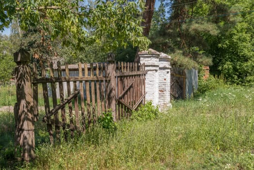 Old ruined wood fence in an ukrainian forest
