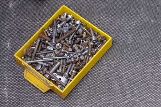 Yellow old box with several screws