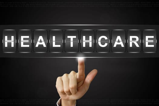 business hand pushing healthcare on Flipboard Display