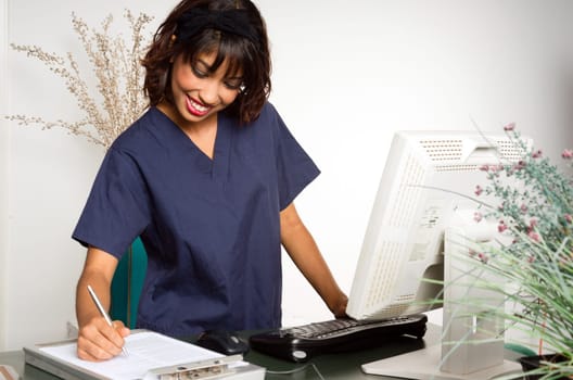 Female employee males nots on a patient chart