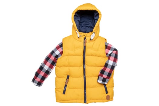 Vest isolated. Close-up of a stylish cozy warm yellow down vest with hood with a red checkered shirt isolated on a white background. Childrens autum and winter clothes.