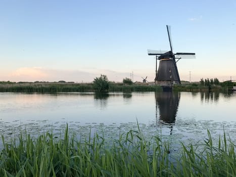Beautiful dutch windmill landscape at the famous Kinderdijk canals, UNESCO world heritage site