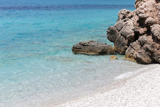 Clear turquoise water rocky beach of Porto Germeno, Attica, Greece