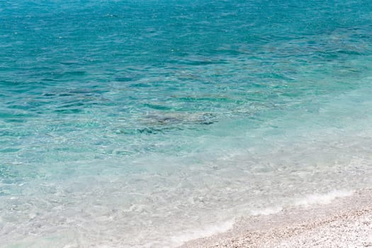 Clear turquoise water rocky beach of Porto Germeno, Attica, Greece