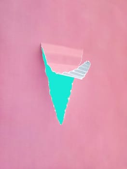 Blank torn paper hole with bent rip edges on empty bacground. A sheet of corrugated paper, a piece in the middle is torn off and the edge is bent. An angry blue paper is visible in the hole