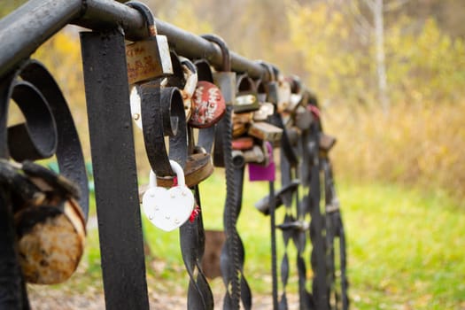 Padlocks with heart shape on bridge, Valentines day or wedding concept card.