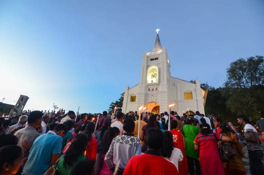 Bukit Mertajam, Penang/Malaysia - Jul 30 2016: Devotees light up candle at feast of St Anne.
