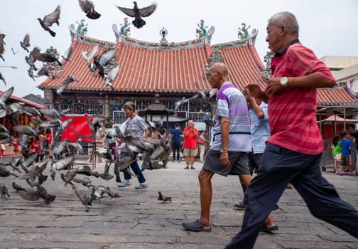 Georgetown, Penang/Malaysia - Aug 07 2016: Old man run at in front of chinese temple.