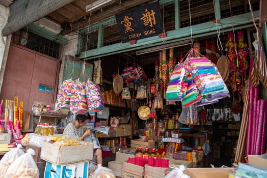 Georgetown, Penang/Malaysia - Aug 07 2016: A woman read newspaper at the joss stick shop house.