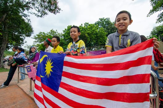 Georgetown, Penang/Malaysia - Aug 31 2016: Kids hold the Malaysia flag during Independence procession.