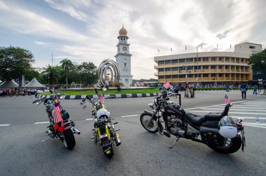 Georgetown, Penang/Malaysia - Aug 31 2016: Motorcycle with Malaysia flag park in front Jubilee Clock Tower.