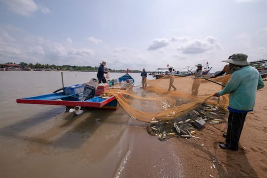 Kuala Muda, Penang/Malaysia - Mar 19 2017: Fisherman clear fishing net.