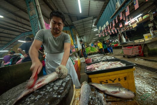 Bukit Mertajam, Penang/Malaysia - Mar 11 2017: Fish monger at stall in market.