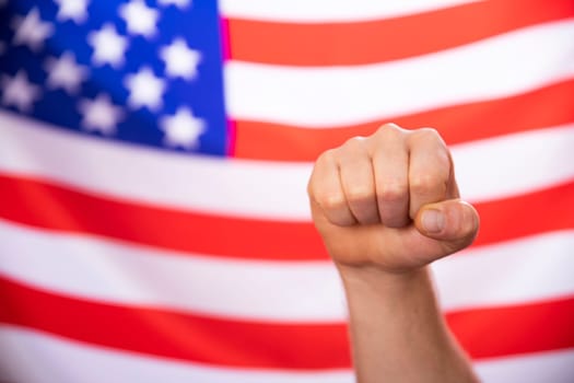 Man's fist over USA flag.United States elections 2020 concept.
