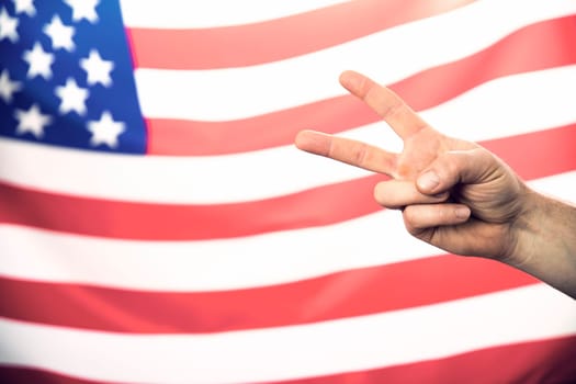 Man's hand showing victory over USA flag.United States elections 2020 concept.