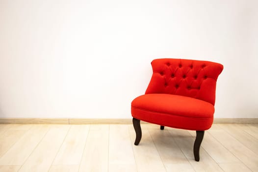 Single red velvet armchair in minimalist interior room