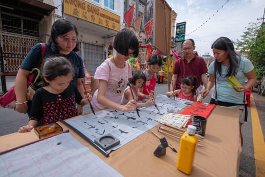George Town, Penang/Malaysia - Jul 07 2017: Local learn chinese calligraphy at street during Georgetown Heritage day.