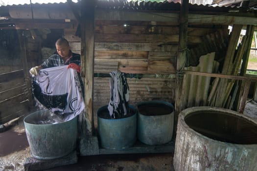 Kota Bahru, Kelantan/Malaysia - Jul 15 2017: An unidentified man wash Batik