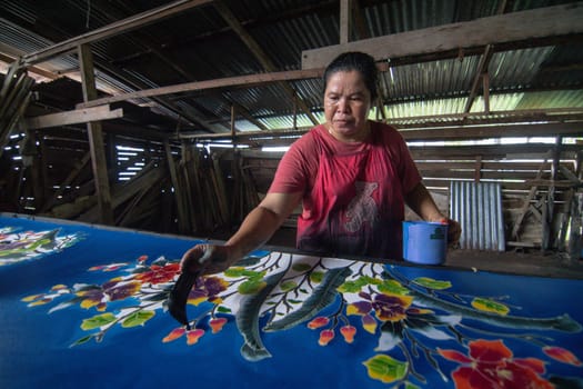 Kota Bahru, Kelantan/Malaysia - Jul 15 2017: Artist paint on batik fabric.