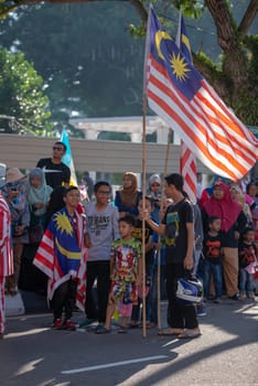 George Town, Penang/Malaysia - Aug 31 2017: Malaysian hold Malaysia flag at street.
