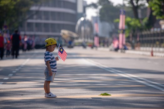 George Town, Penang/Malaysia - Aug 31 2017: A kid hold Malaysia flag.