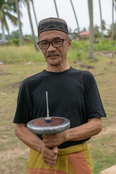 Kota Bahru, Kelantan/Malaysia - Jul 15 2017: A man hold gasing.