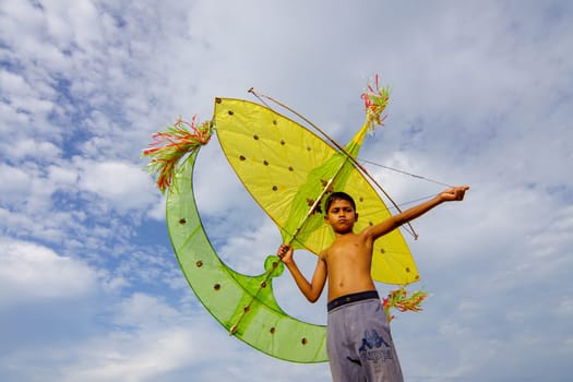 Kota Bahru, Kelantan/Malaysia - Jul 15 2017: Asian kid play traditional moon kite (wau bulan).