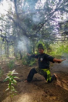 Kota Bahru, Kelantan/Malaysia - Jul 15 2017: Silat art master practice in fog jungle.