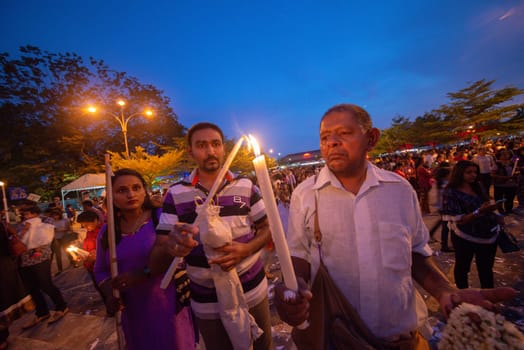 Bukit Mertajam, Penang/Malaysia - Jul 29 2017: Devotees light up candle during St Anne feast.